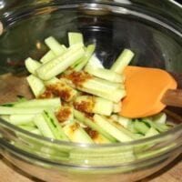 tossing cucumber salad