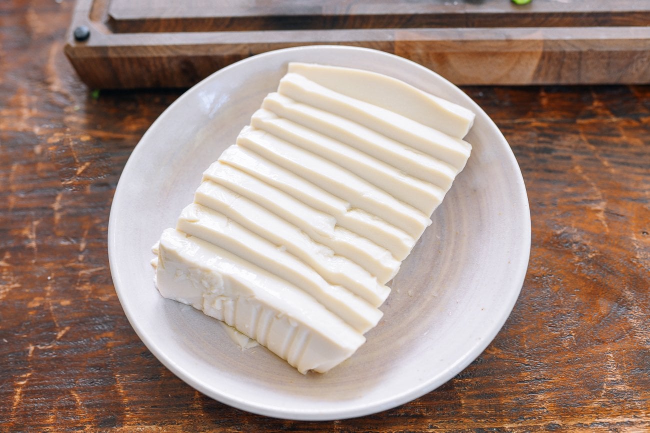 sliced soft tofu in shallow dish
