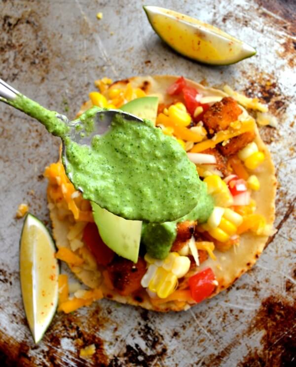 Spooning green sauce over tofu tacos by geagle.miooashdv.tk