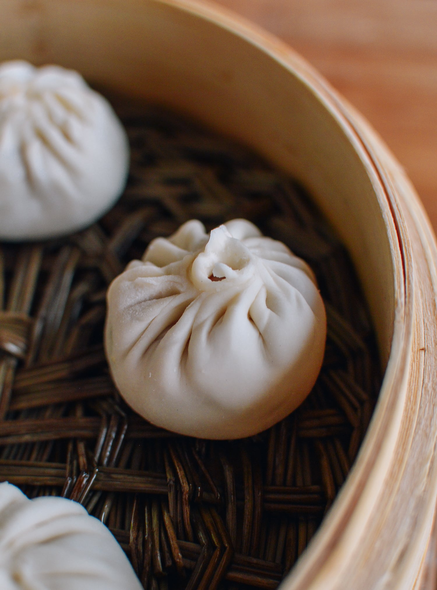 Xiaolongbao in bamboo steamer before cooking