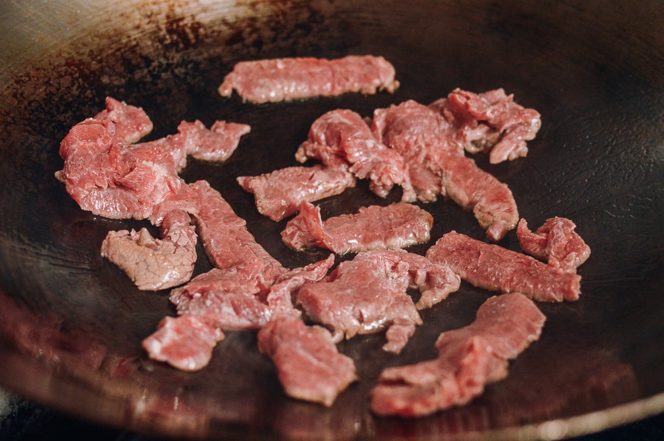 beef pieces searing in wok