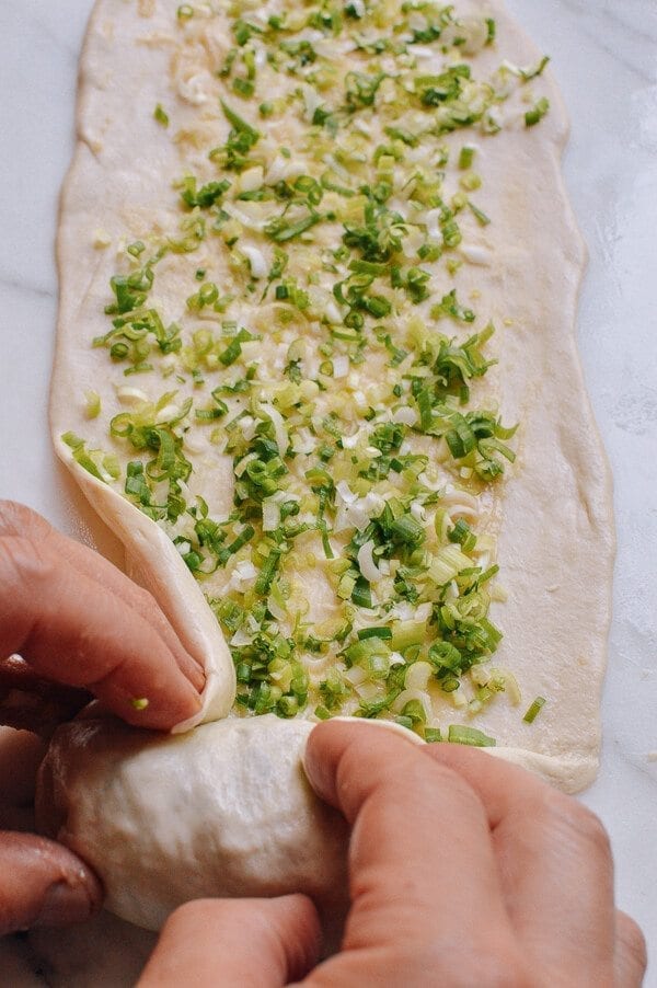 wrapping scallion in dough for Shanghai Scallion Pancakes, by geagle.miooashdv.tk