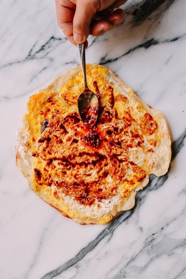 spreading sauce on Jidan Bing: The Chinese Breakfast of Champions, by geagle.miooashdv.tk