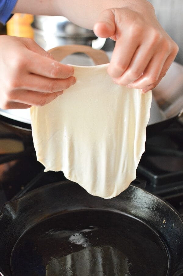 placing thin dough in pan for Jidan Bing, by geagle.miooashdv.tk
