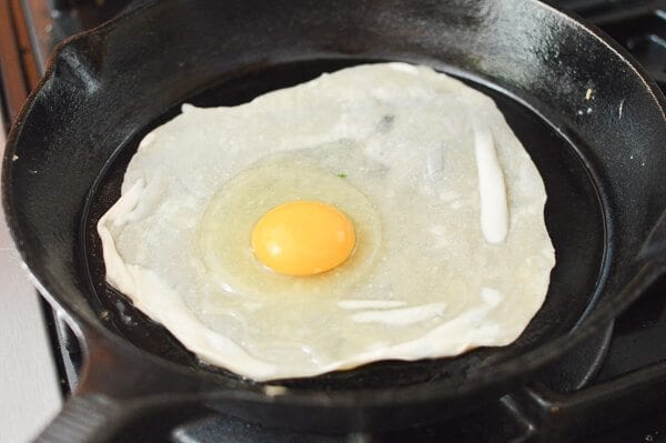 raw egg on thin dough in pan for Jidan Bing, by geagle.miooashdv.tk