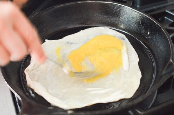 stirring raw egg on thin dough in pan for Jidan Bing, by geagle.miooashdv.tk