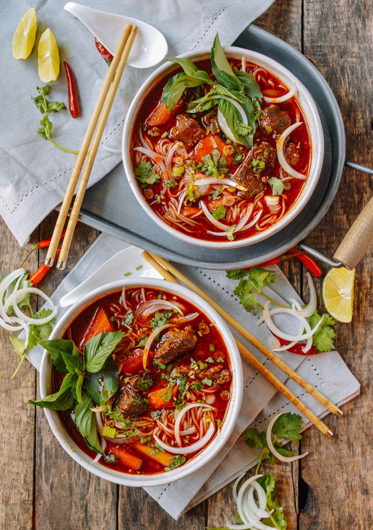 Two bowls of bho kho with rice noodles