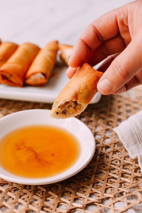 Dipping spring roll in rice vinegar