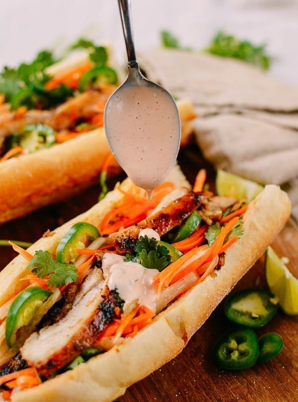 Spooning Sriracha Mayo on Banh Mi, geagle.miooashdv.tk