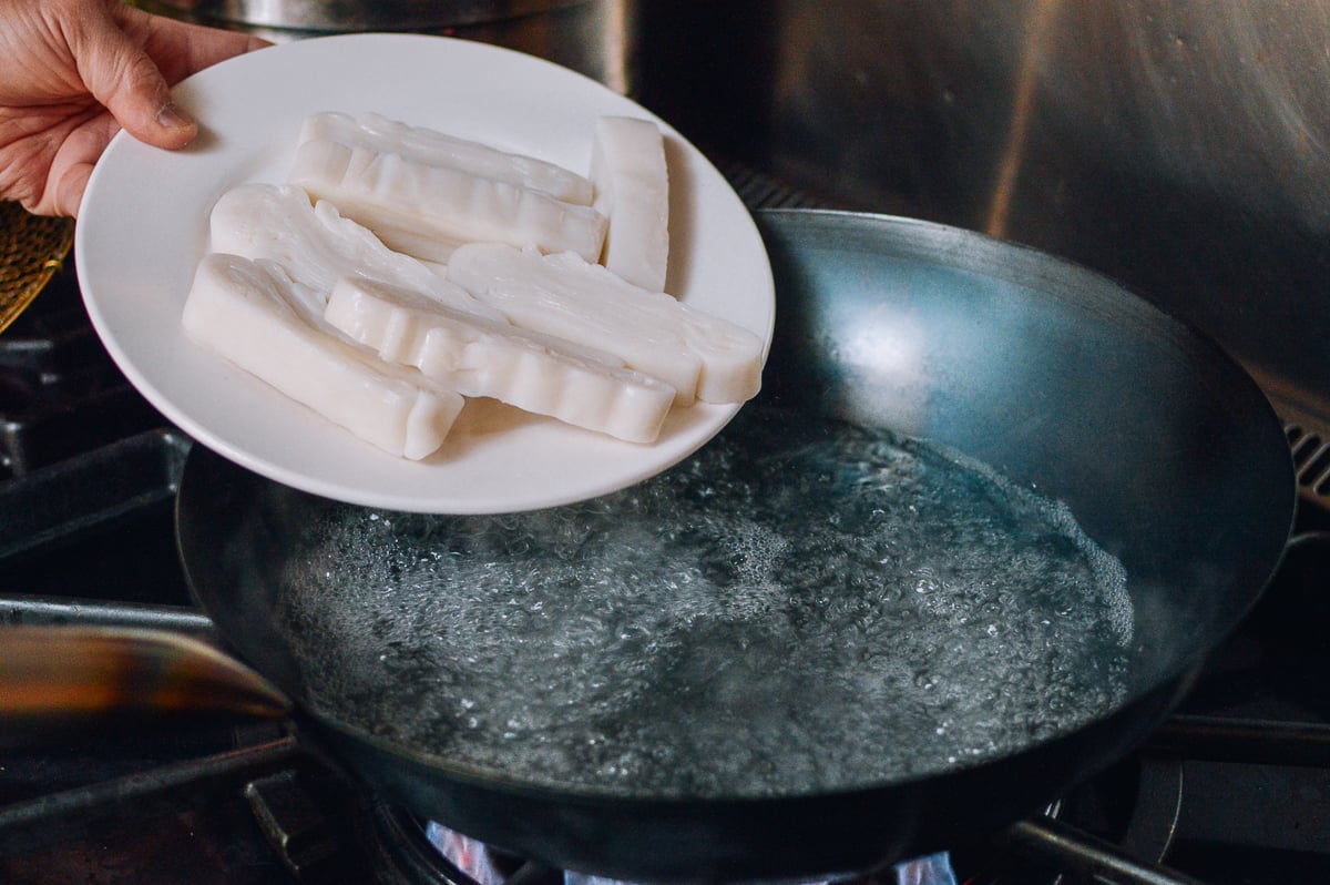 Putting rice noodles in wok filled with boiling water, geagle.miooashdv.tk