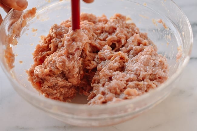 Stirring Chinese meat mixture until it resembles a paste, geagle.miooashdv.tk