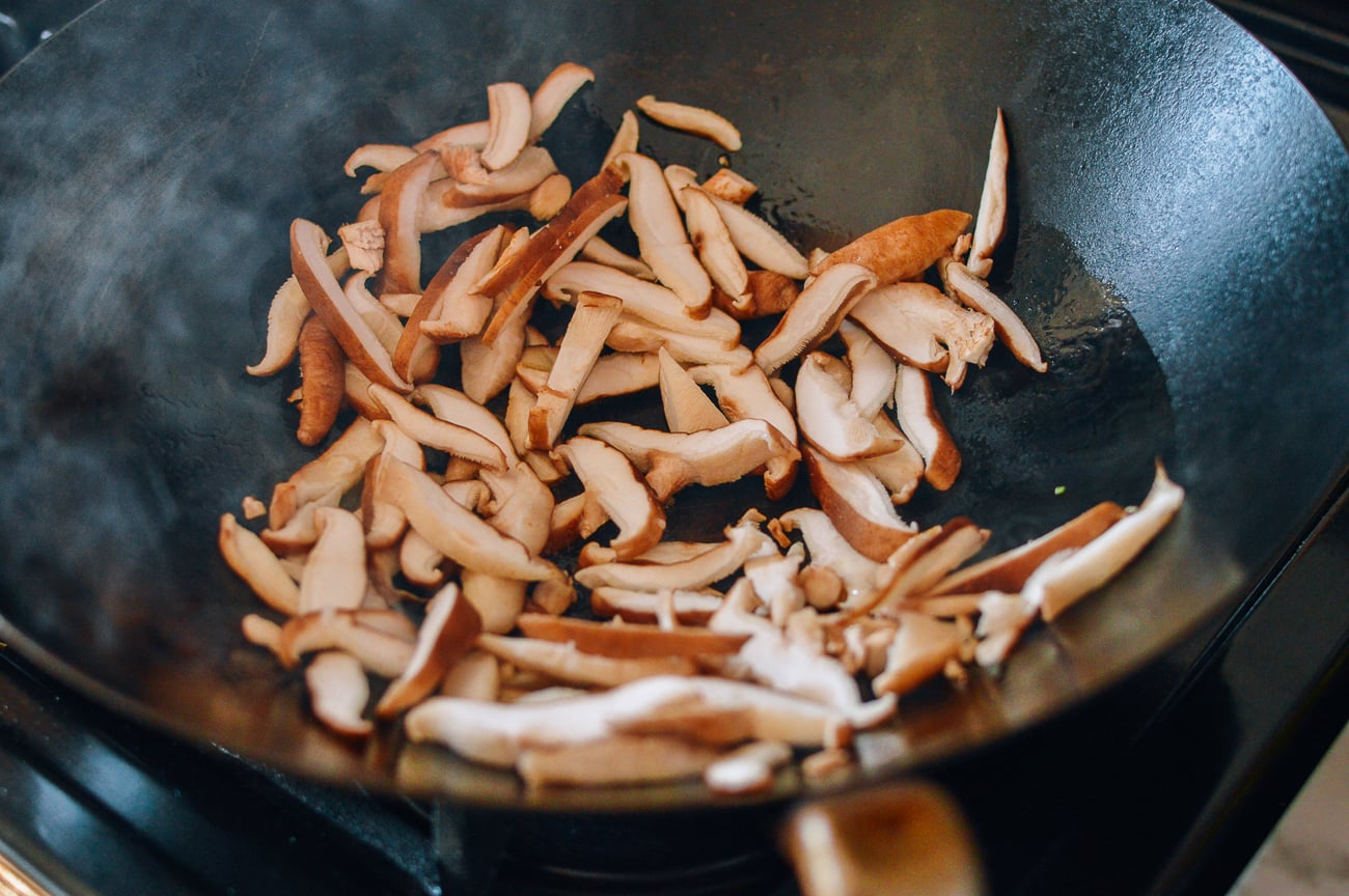 sliced shiitake mushrooms in wok