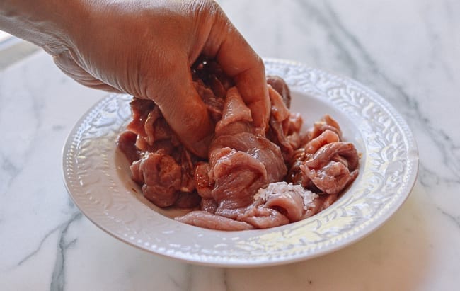 Massaging marinade ingredients into pork, geagle.miooashdv.tk