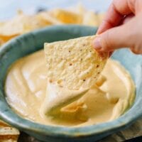 Dipping tortilla chip into plain vegan queso, geagle.miooashdv.tk