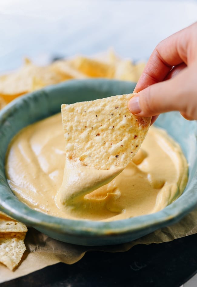 Dipping tortilla chip into plain vegan queso, geagle.miooashdv.tk