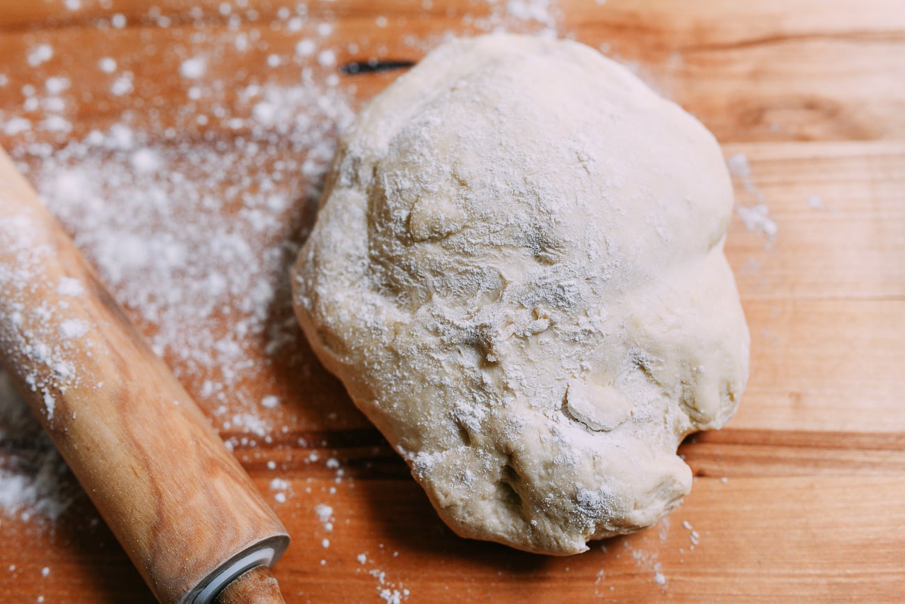Enriched dough on board with rolling pin