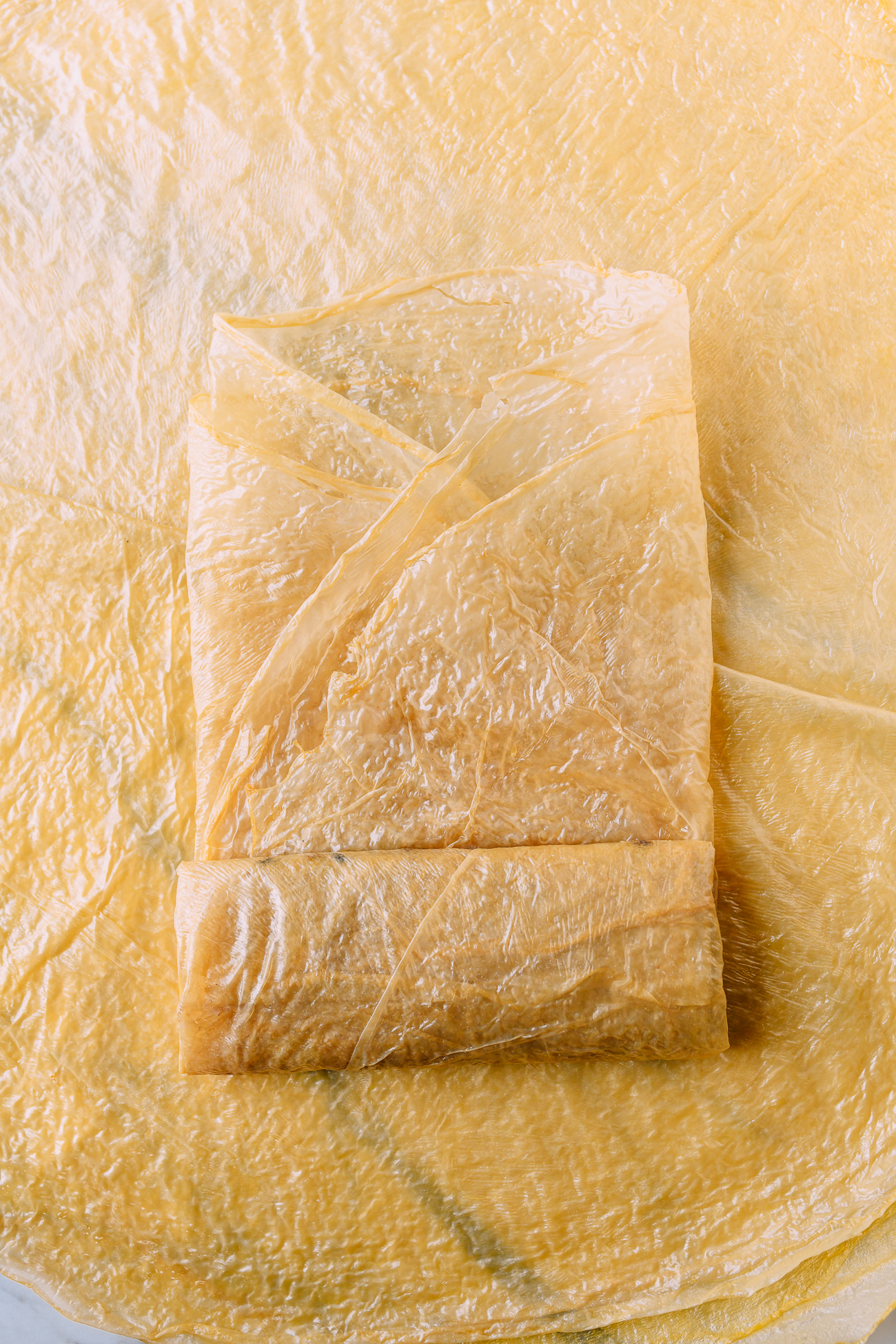 Rolling bean curd sheets around filling