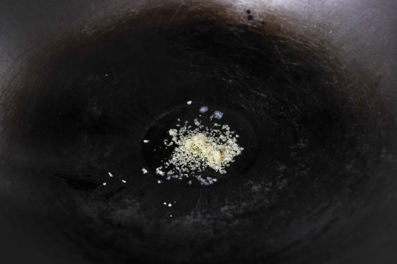 Frying minced ginger in wok