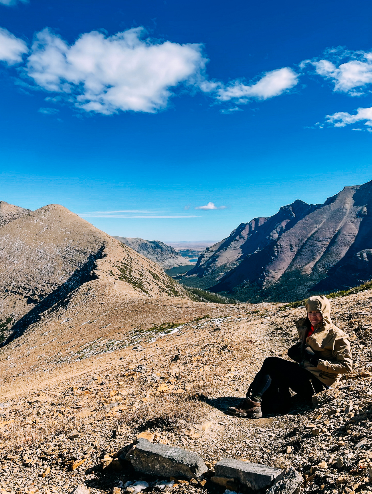 Sarah sitting down on ridge. 