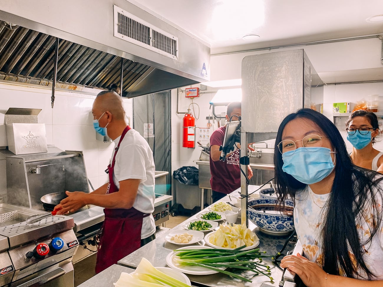 Kaitlin in the Xi'an Famous Foods Chelsea kitchen