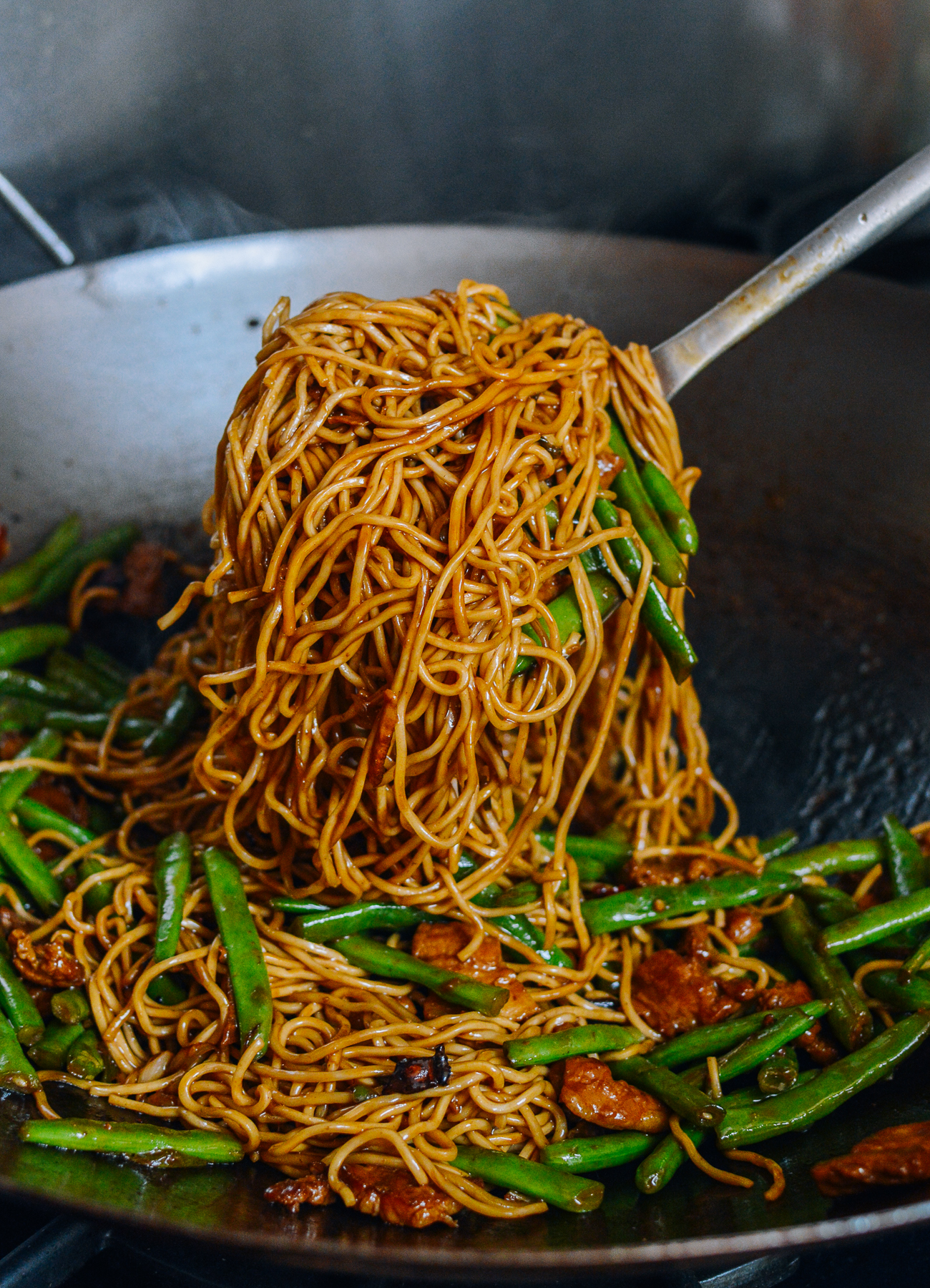 Lifting noodles with wok spatula