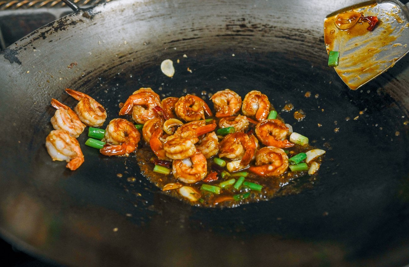 cooking kung pao shrimp in wok