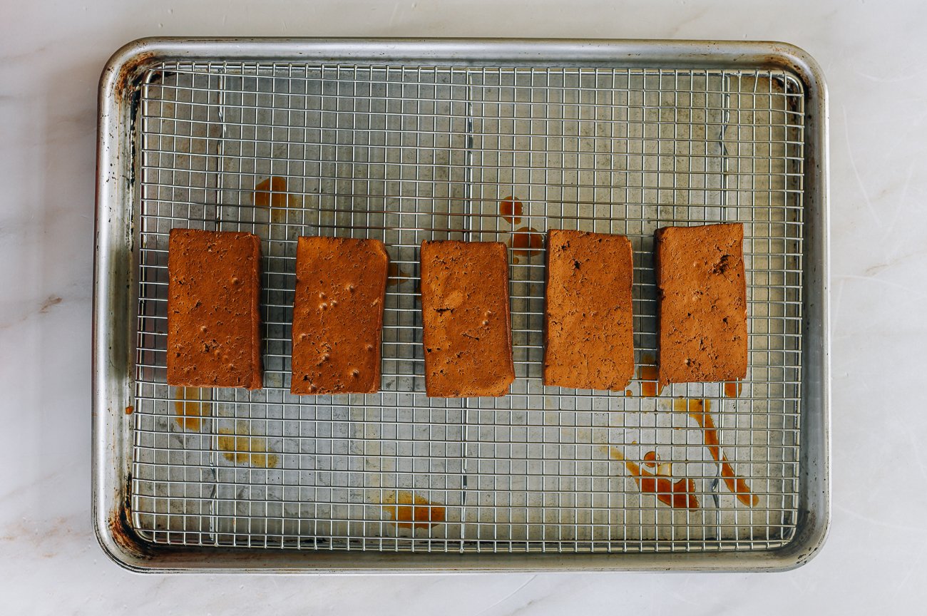 braised tofu pieces on rack on baking sheet