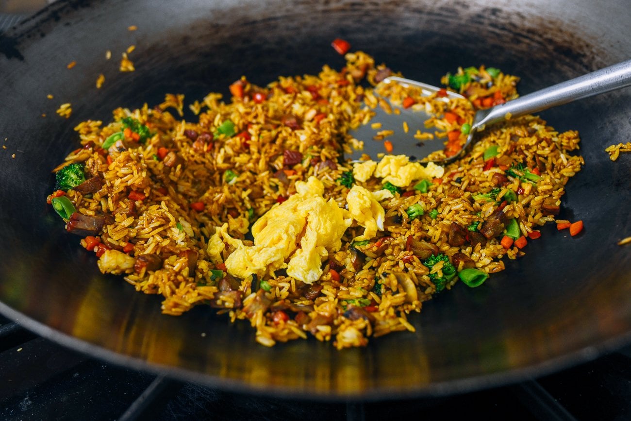 adding eggs to fried rice