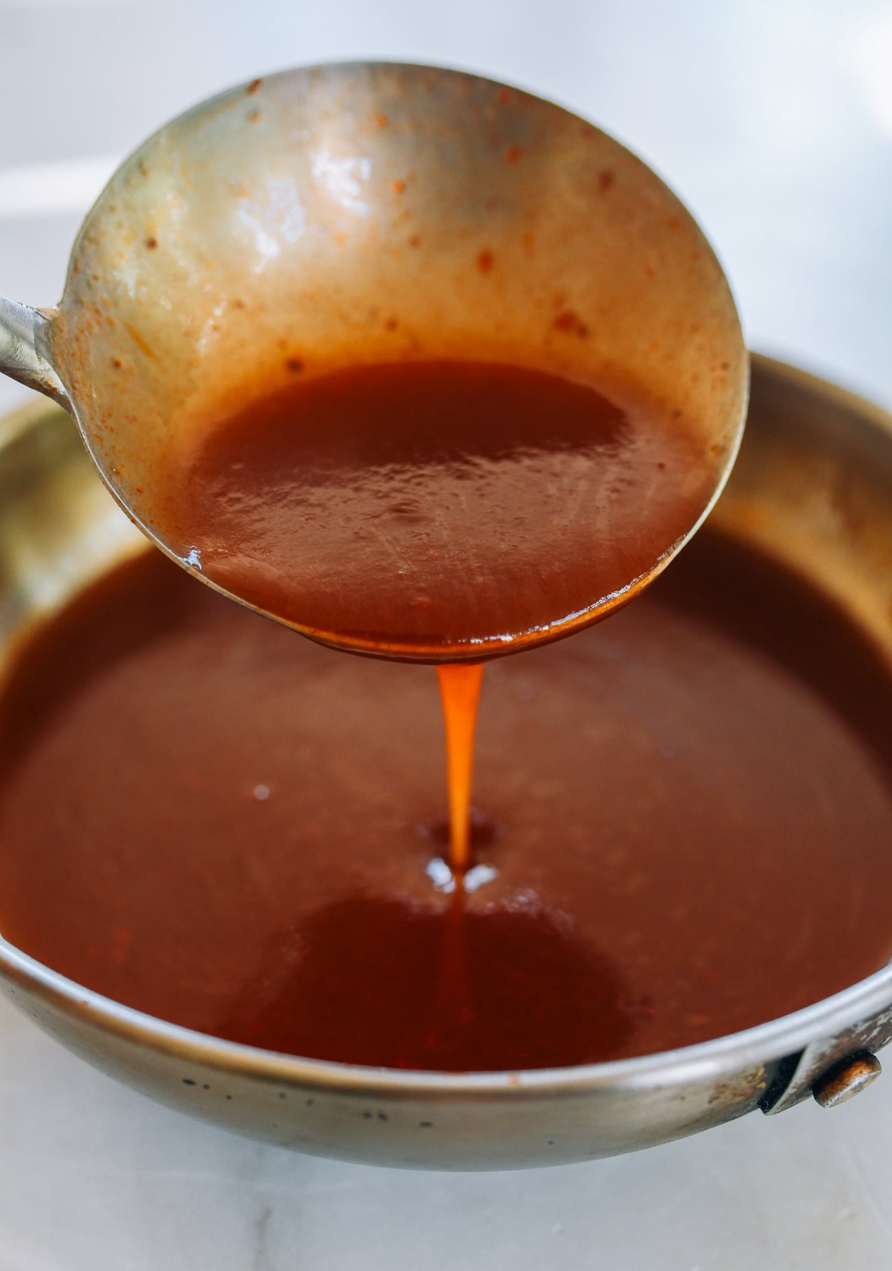 ladle full of sweet and sour sauce