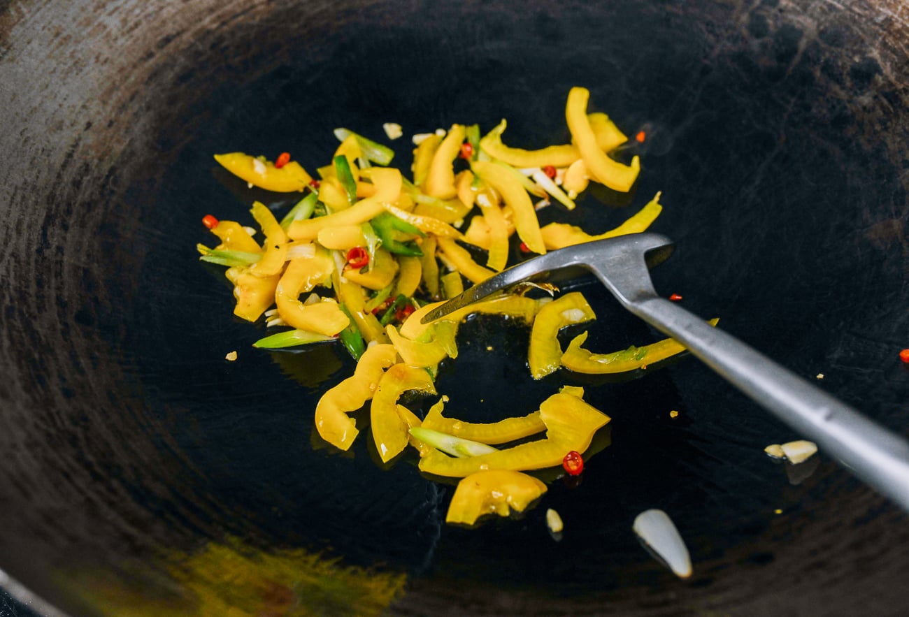 Bell pepper, scallion, Thai chili, and garlic in wok