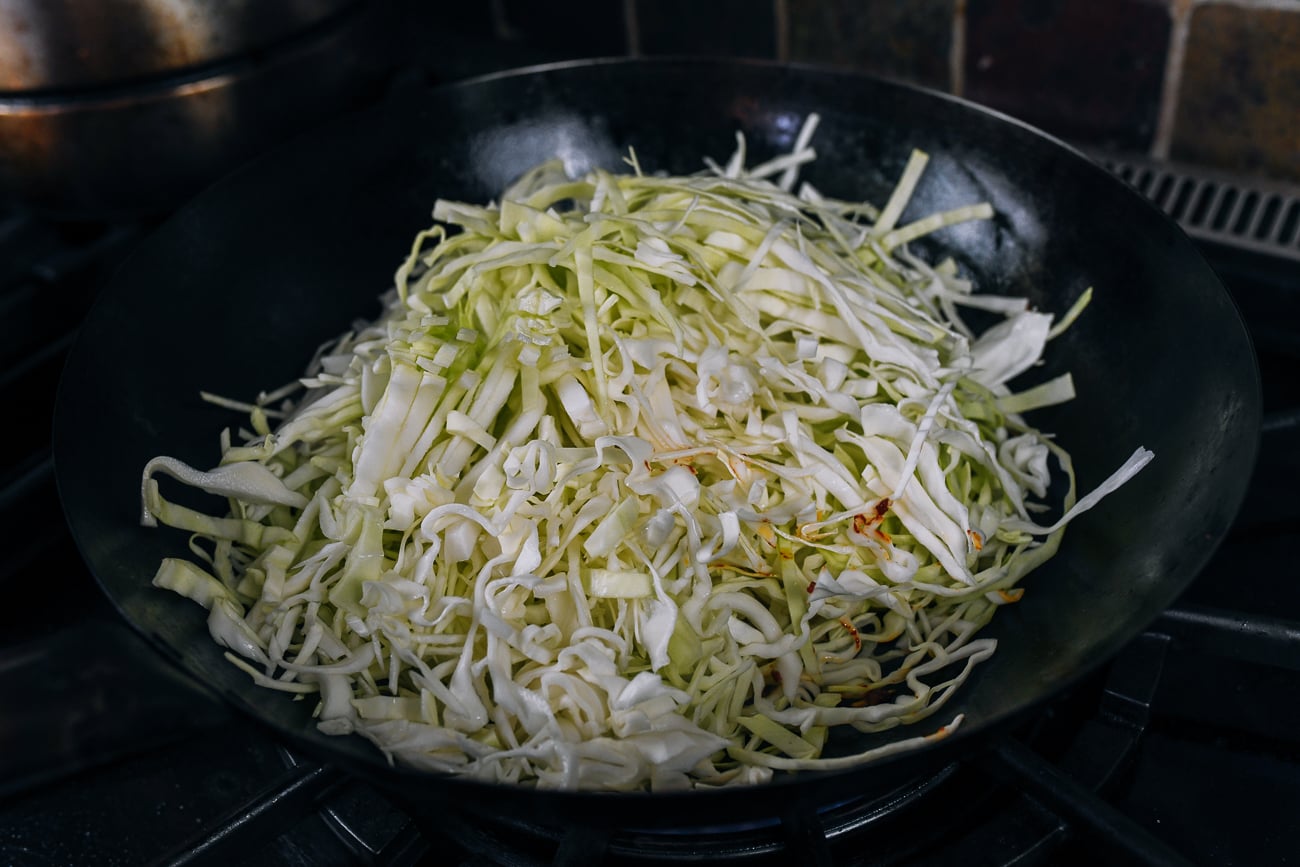 shredded cabbage in wok