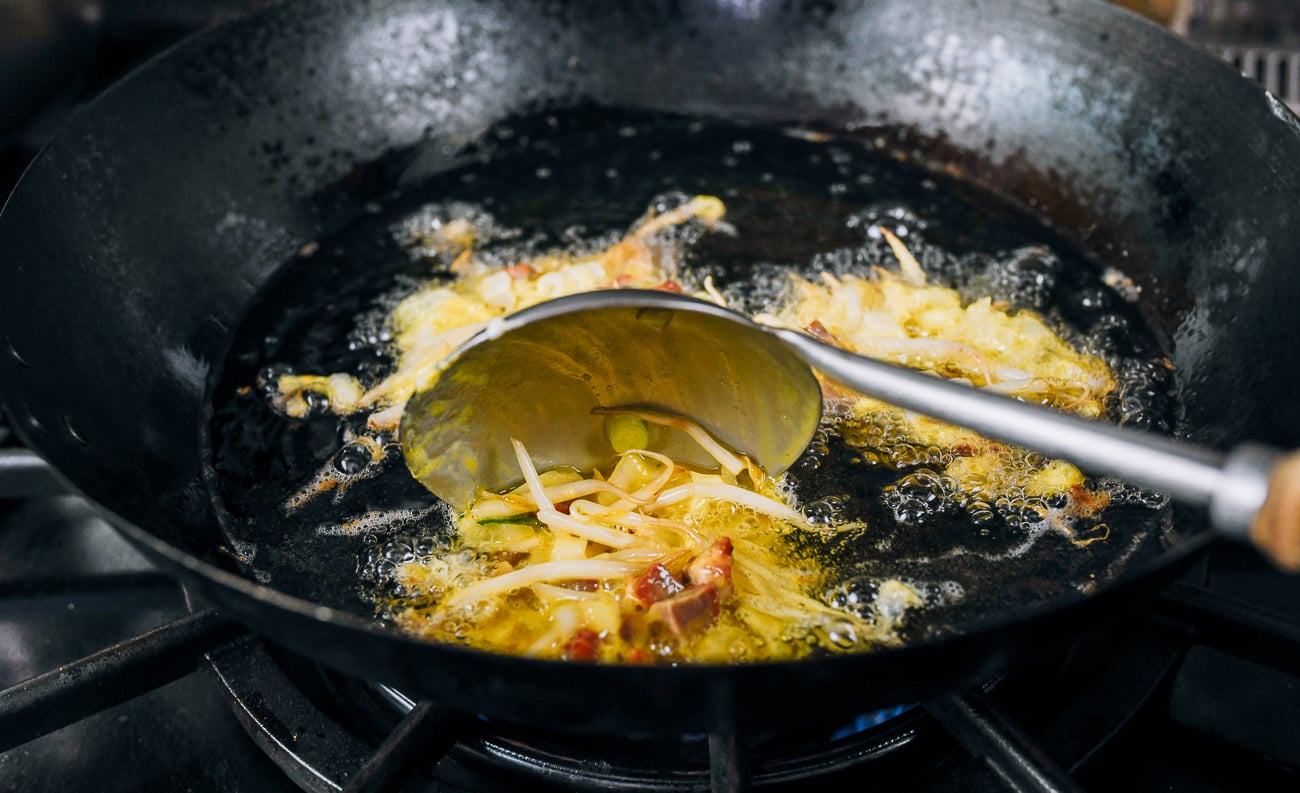 adding egg foo young patties to oil