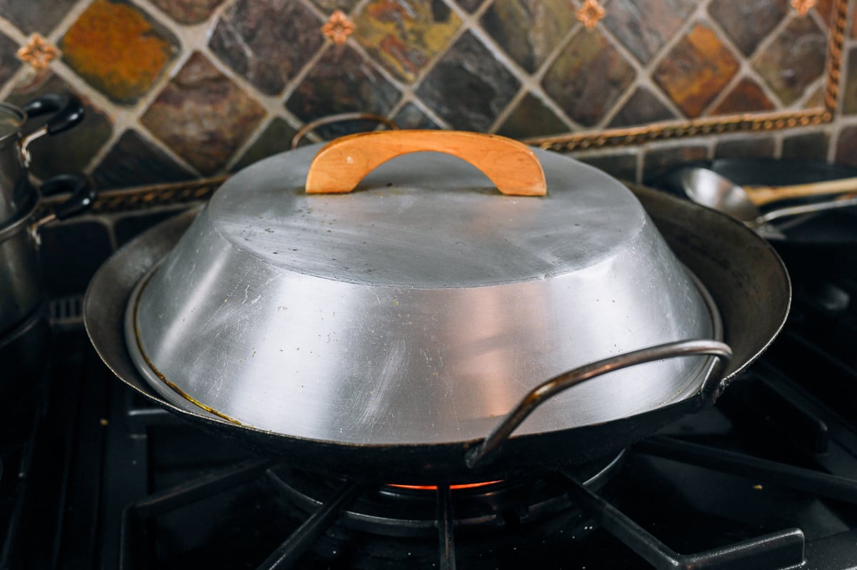 covered wok on stove