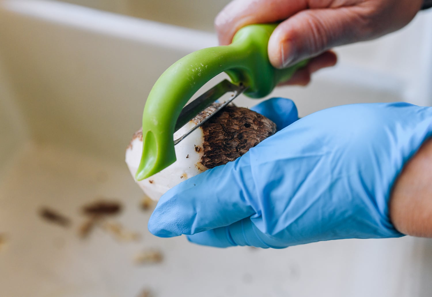 peeling small taro