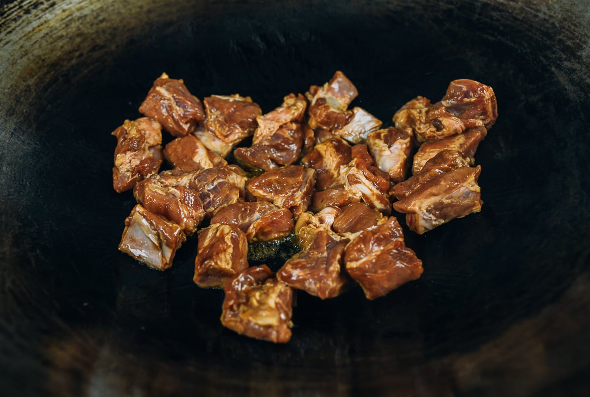 Marinated pork rib pieces in wok