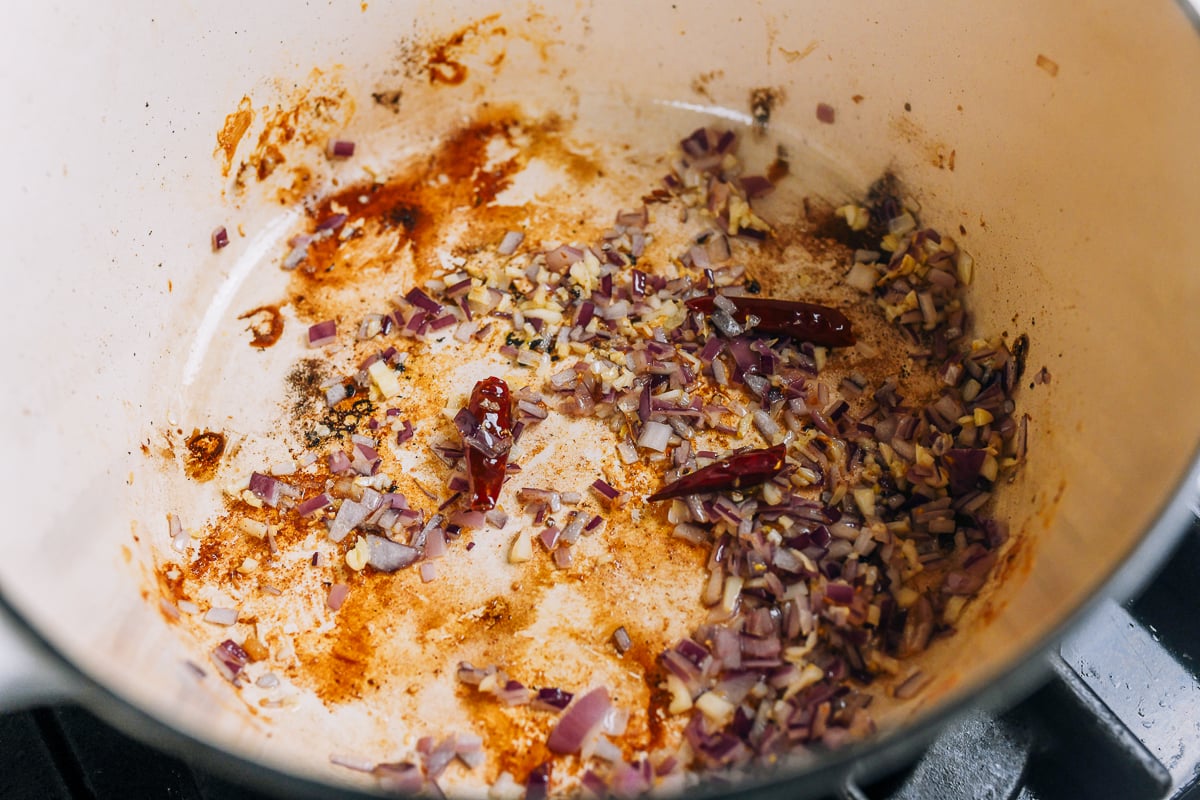 cooking aromatics in chicken drippings in pot
