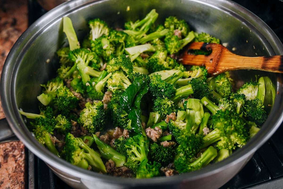 cooking broccoli and sausage in skillet