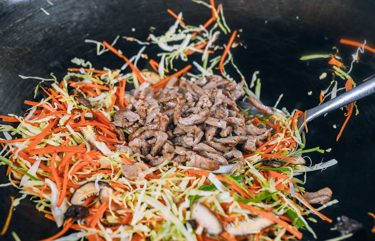 adding shredded pork to moo shu