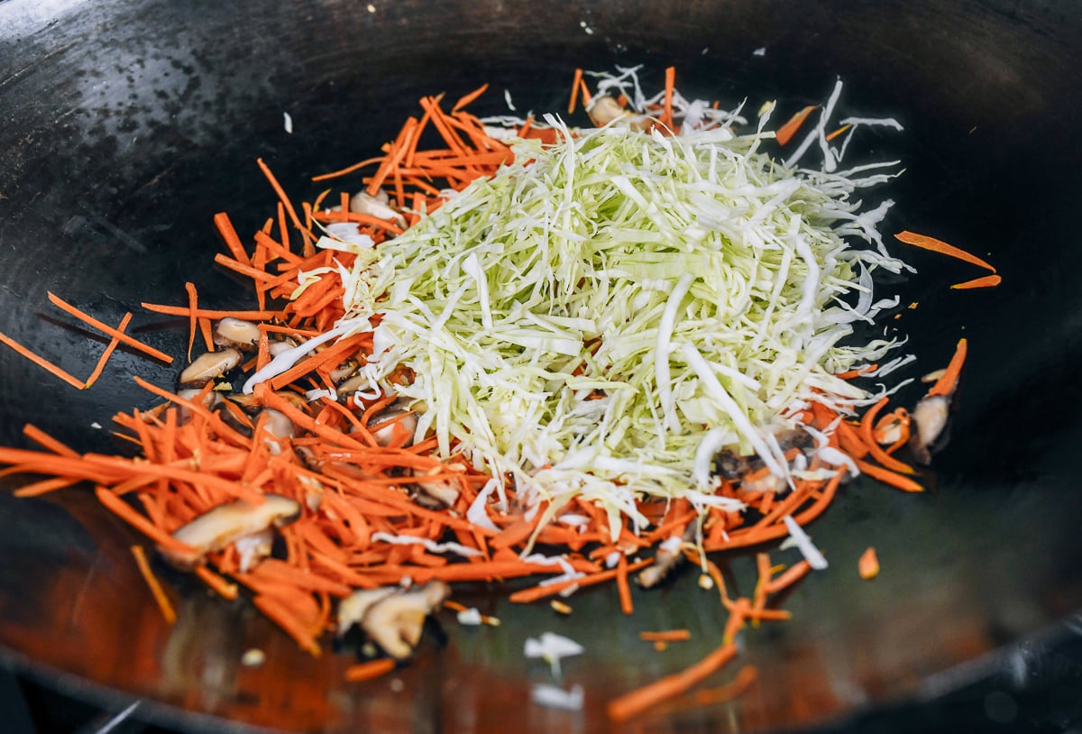 stir-frying shredded cabbage and carrot