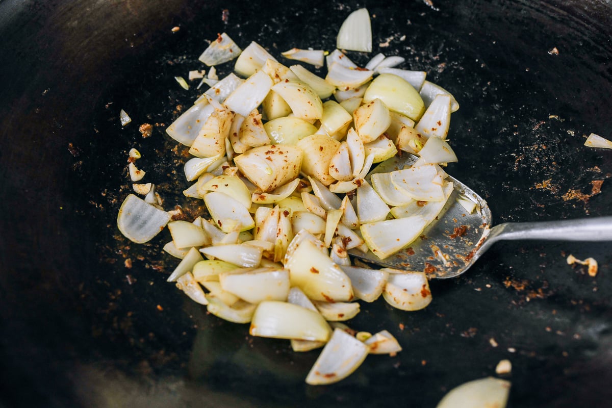 stir-frying onions in wok