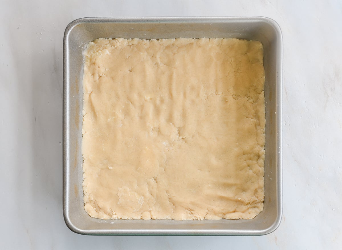 dough pressed into 9x9 inch square pan for crust