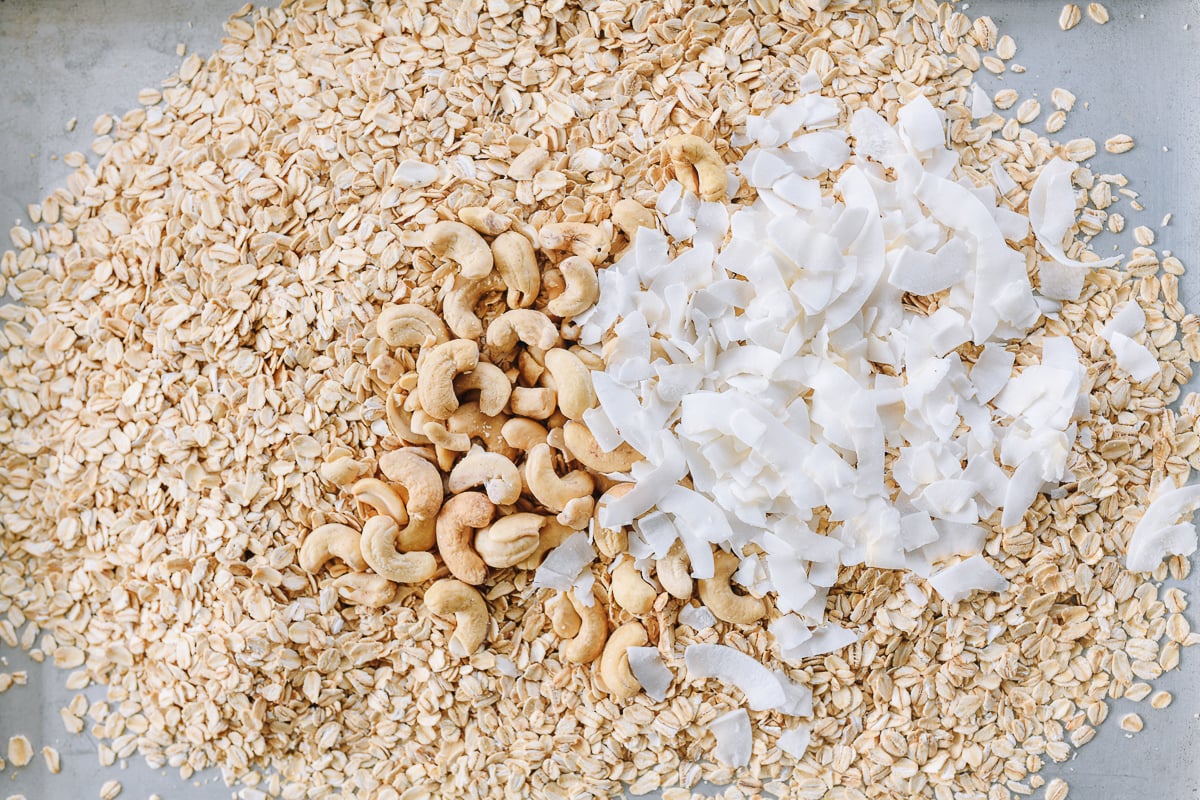 oats, cashews, and coconut flakes on baking sheet