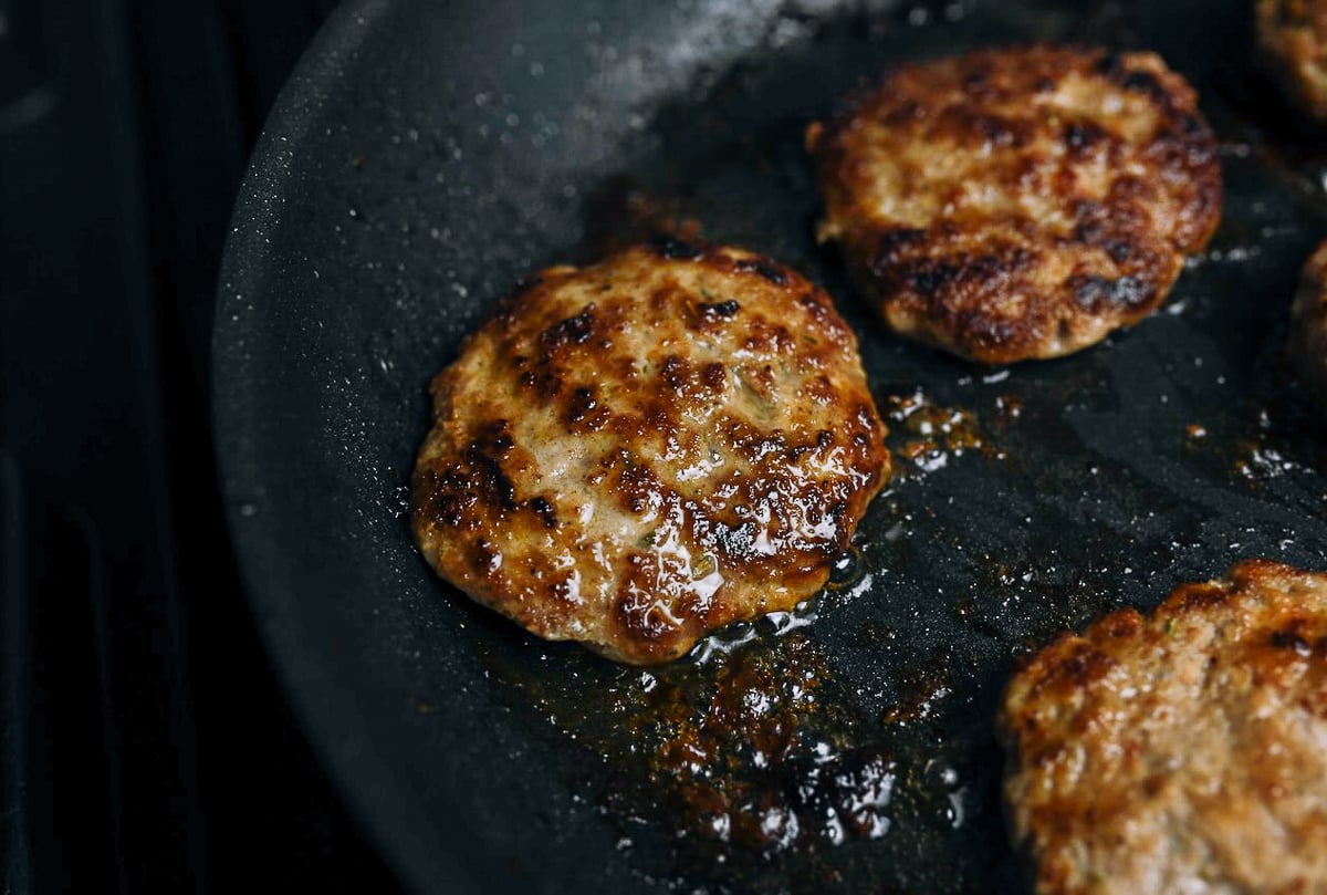 frying turkey sausage patties in pan