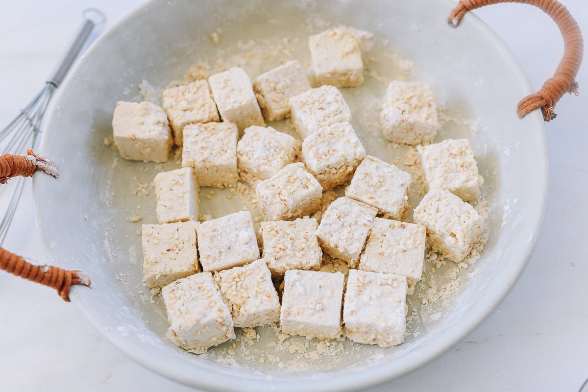 dredging tofu with cornstarch and sesame seeds