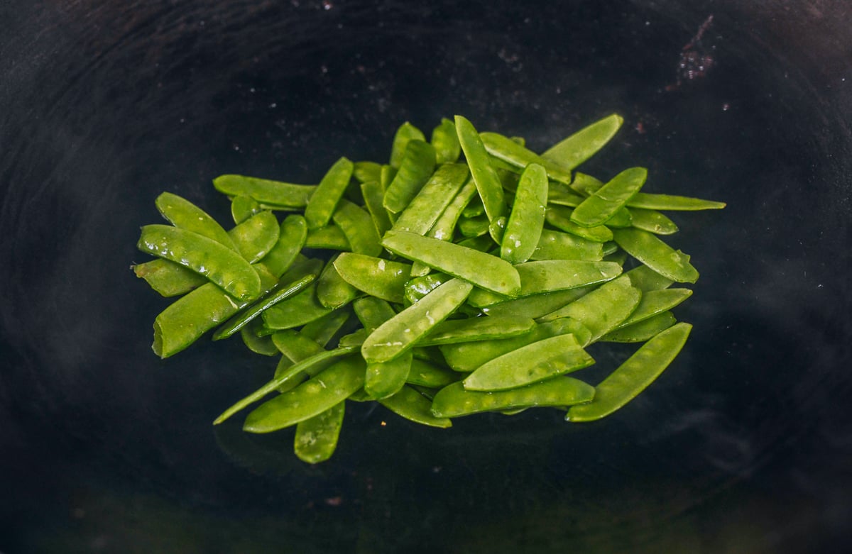 cooking snow peas in wok