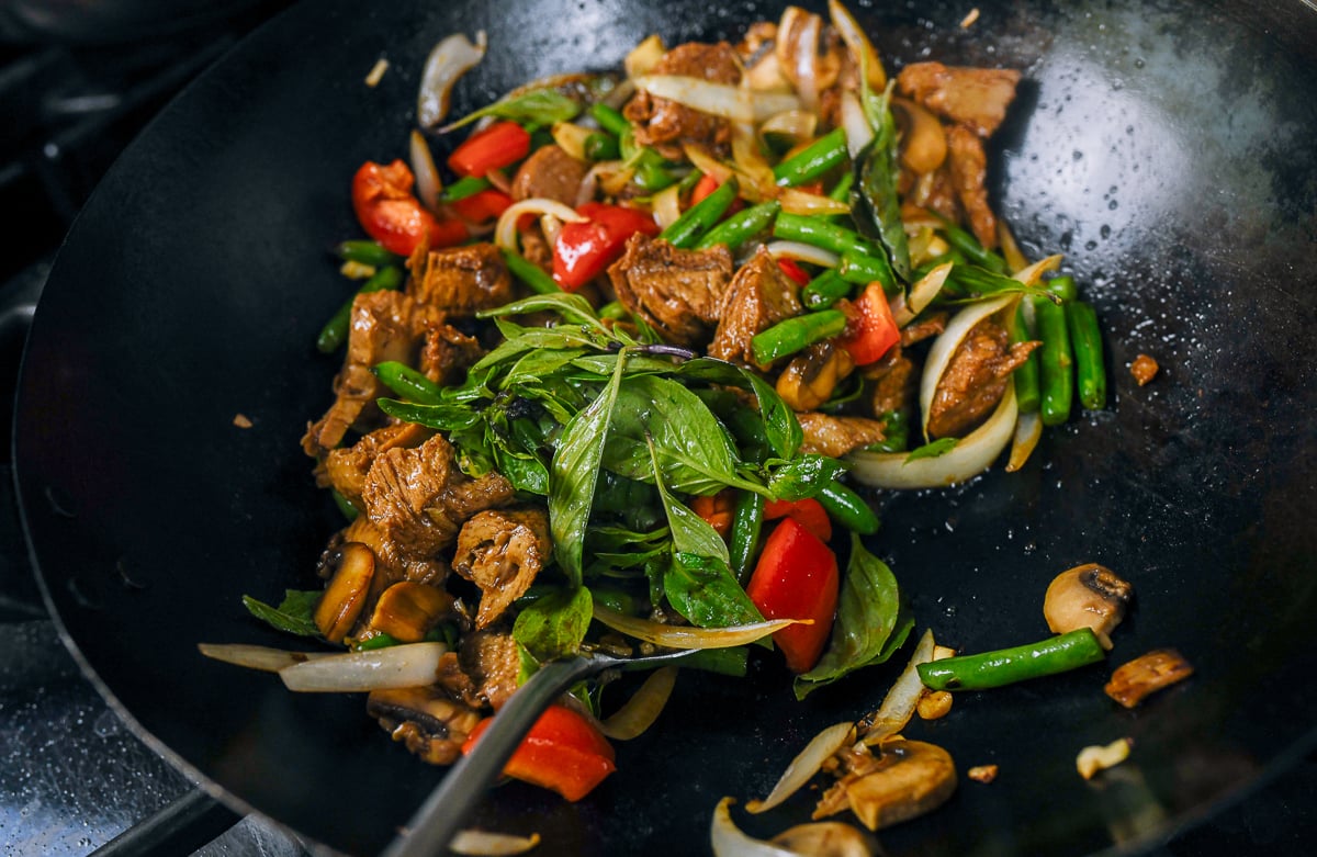 adding thai basil to mock duck stir-fry